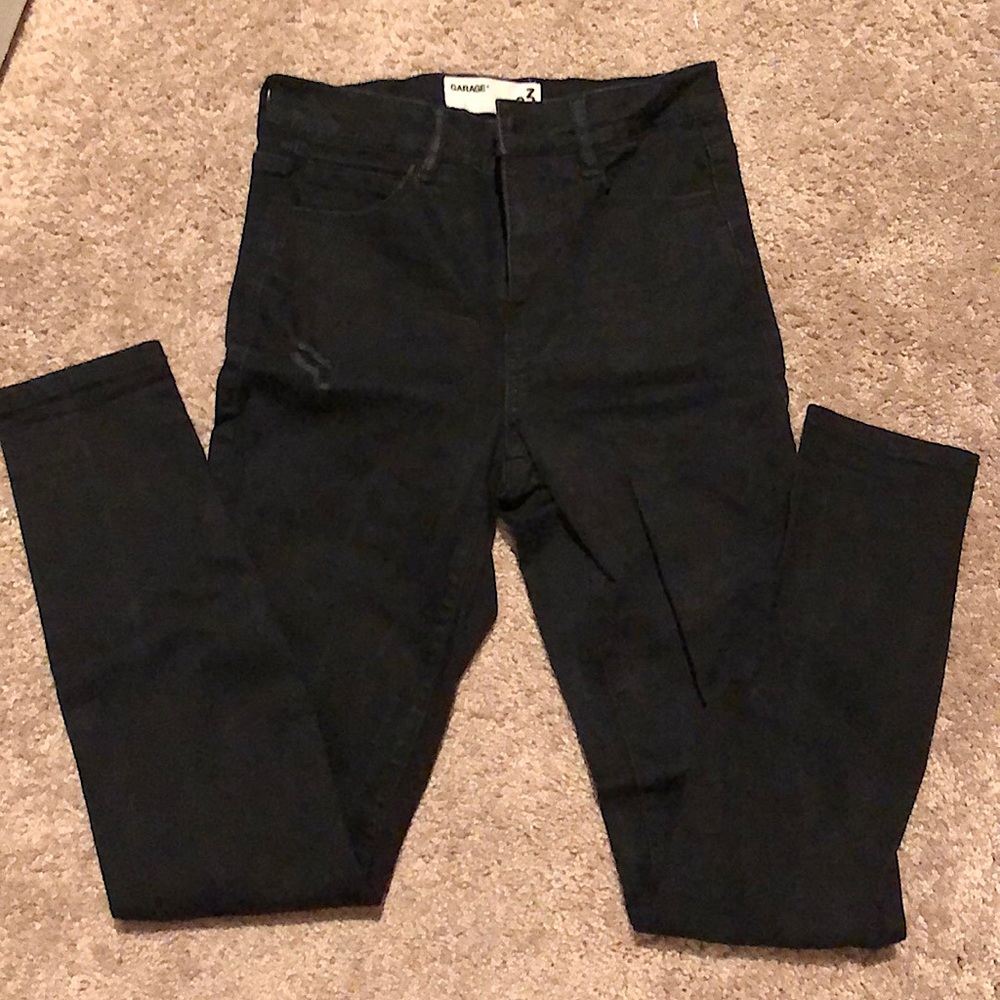 Black high waisted jeans with rips at the knees. Hardly worn.